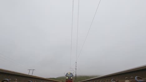 lkab train and iore locomotive passing over the camera on a cloudy day