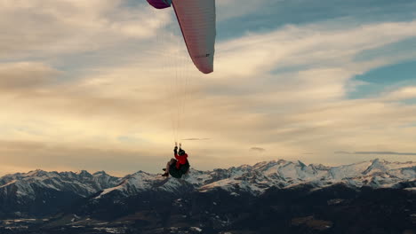 paragliding over the alps at sunset