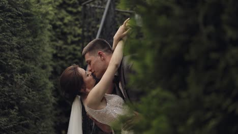 newlyweds, caucasian groom with bride stay on stairs in park, wedding couple, man and woman in love