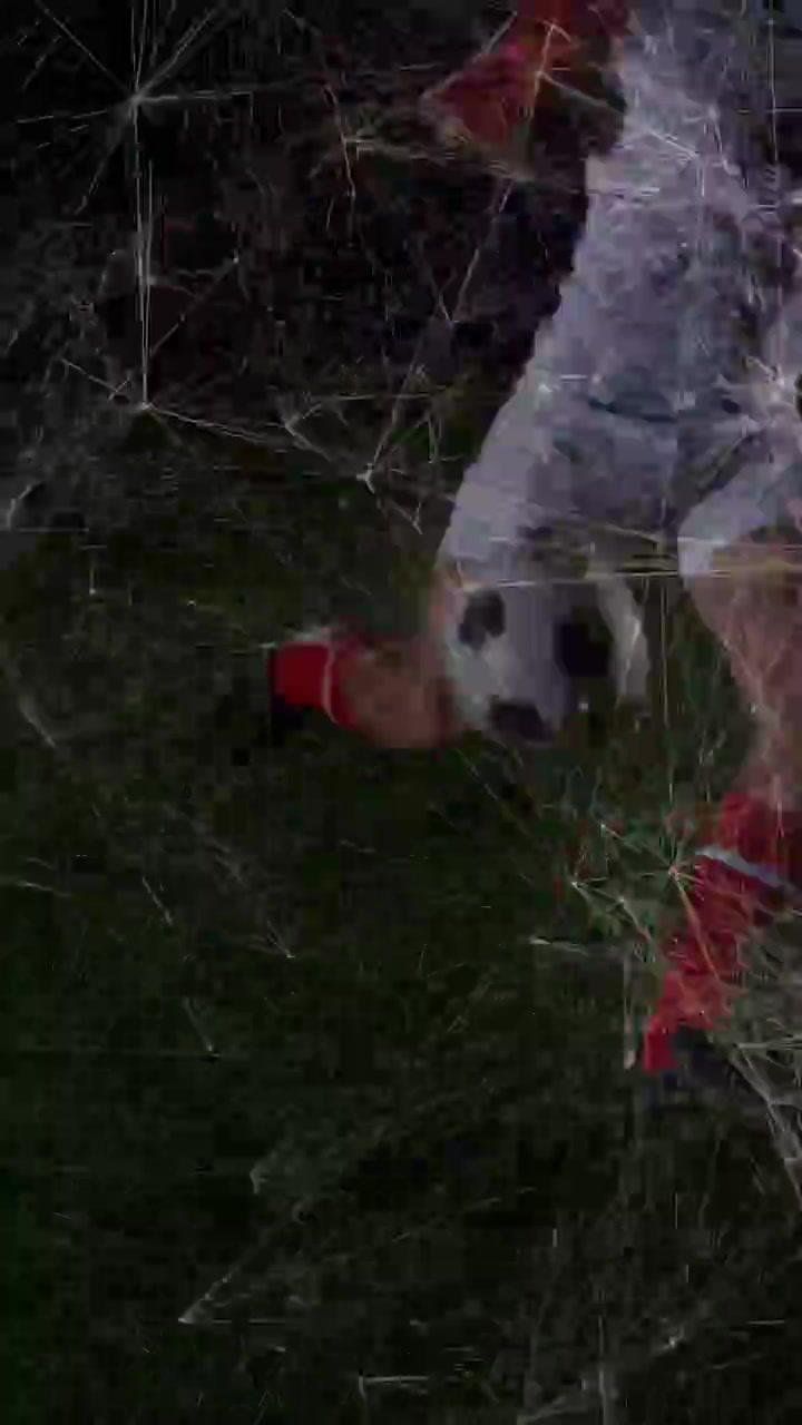 Vertical video: Athlete entering right tapping ball, dribbling on turf, web-overlay tracking ball