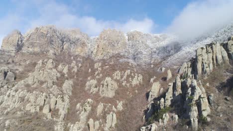 snowy mountain range with rock formations