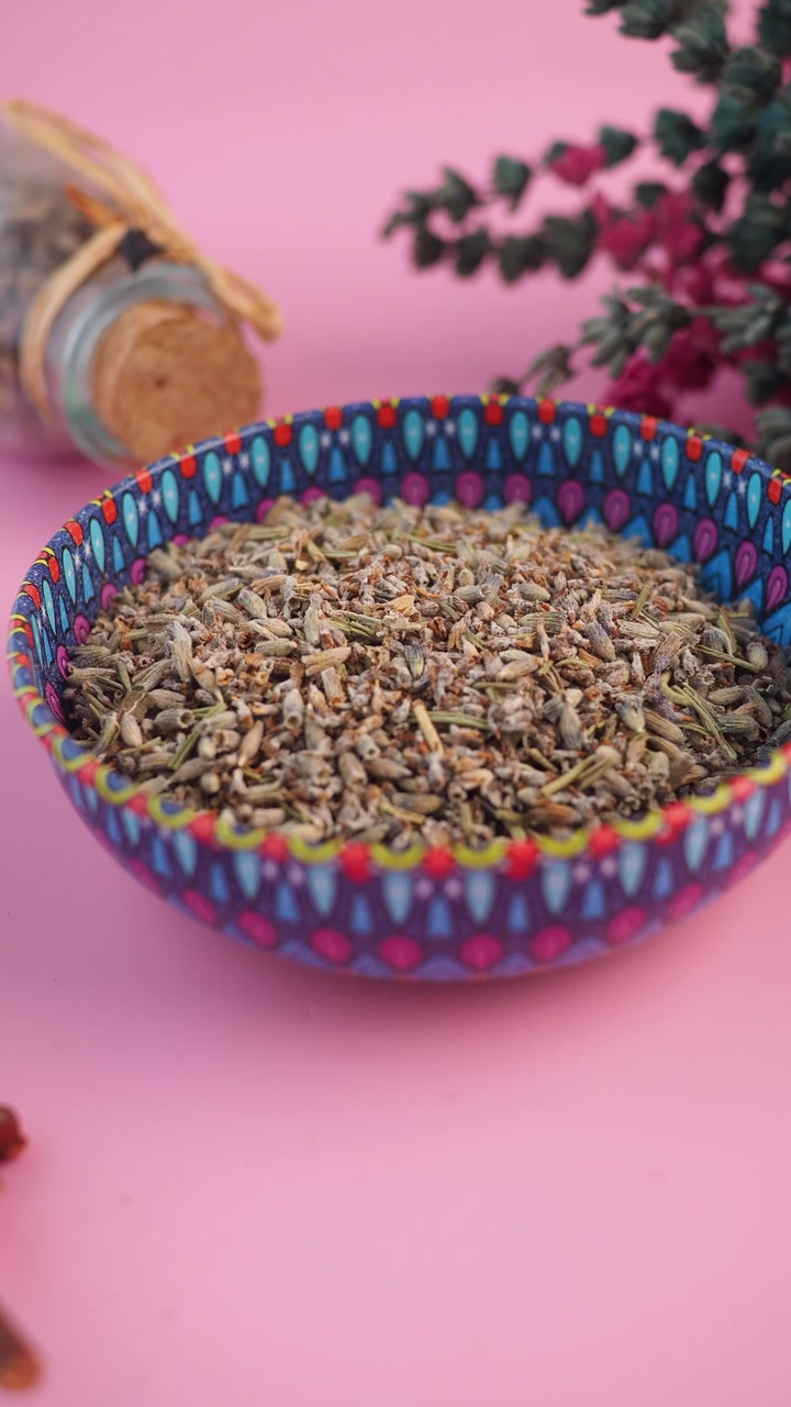 Dried Lavender Buds in a Colorful Bowl on Pink Background