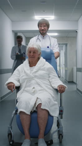 hospital staff assisting elderly patient