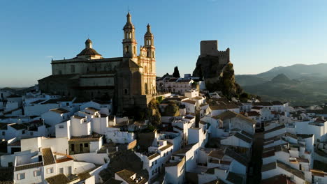 Flying-On-The-Neoclassic-Cathedral-At-Olvera-Village-During-Sunrise-In-Cádiz,-Andalusia,-Spain