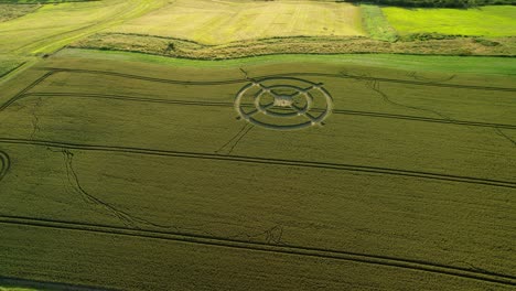 Hackpen-hill-strange-crop-circle-pattern-in-rural-grass-farming-meadow-aerial-view-wide-left-rotating-shot