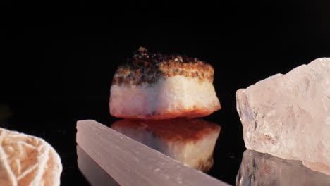 still life of gems sparkling as dolly gracefully moves towards a closeup of citrine under studio lighting on a black background