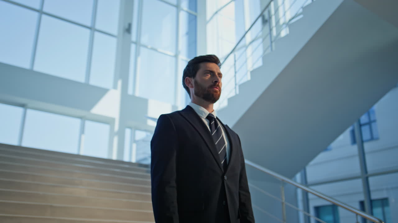 Elegant businessman standing staircase modern building closeup. Confident man