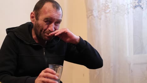 a young man with a blind eye suffers from alcoholism trying to quit the problem of alcohol dependence a young man with a blind eye suffers from alcoholism