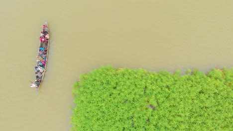 4k-Aerial-Top-Down-shot-of-People-in-a-Row-Boat-getting-evacuated-to-land-area-in-Majuli-river-island-submerged-in-the-Brahmaputra-Monsoon-floods