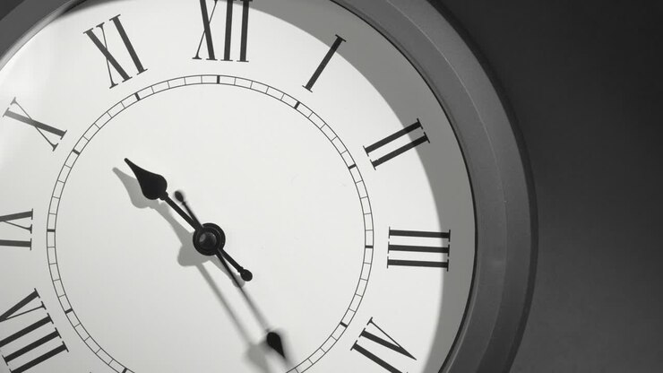 Latin Clock Face in Time Lapse on Dark Grey Wall