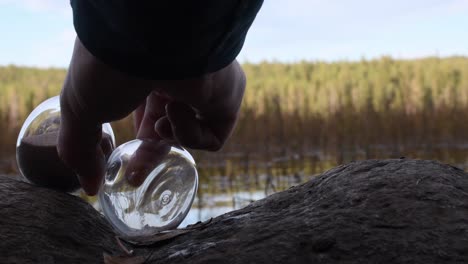 white male hand rotate hour glass and fail it