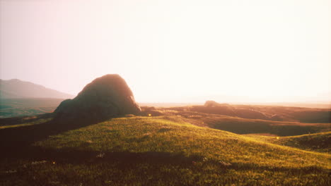 stunning sunset view over green grass field and mountains