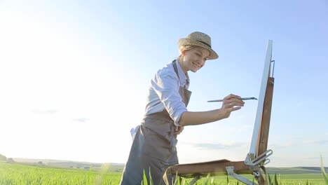 girl artist paints a picture with oil paints