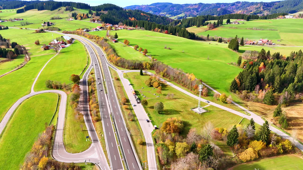 Autumn road in green valley. A German valley with bright fields, forests and a highway in autumn