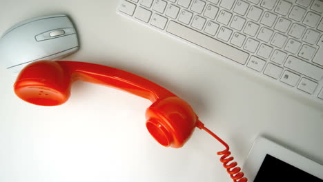 red receiver falling onto a white desk