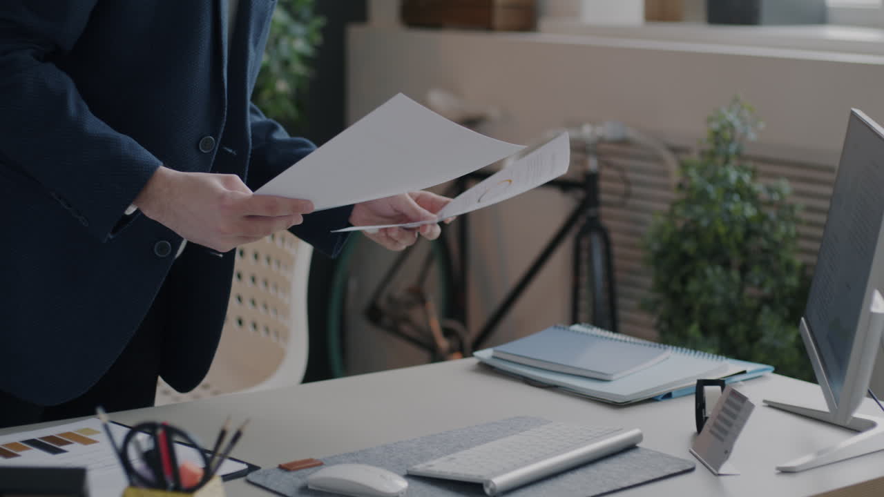 Businessperson Reviewing Documents at Desk