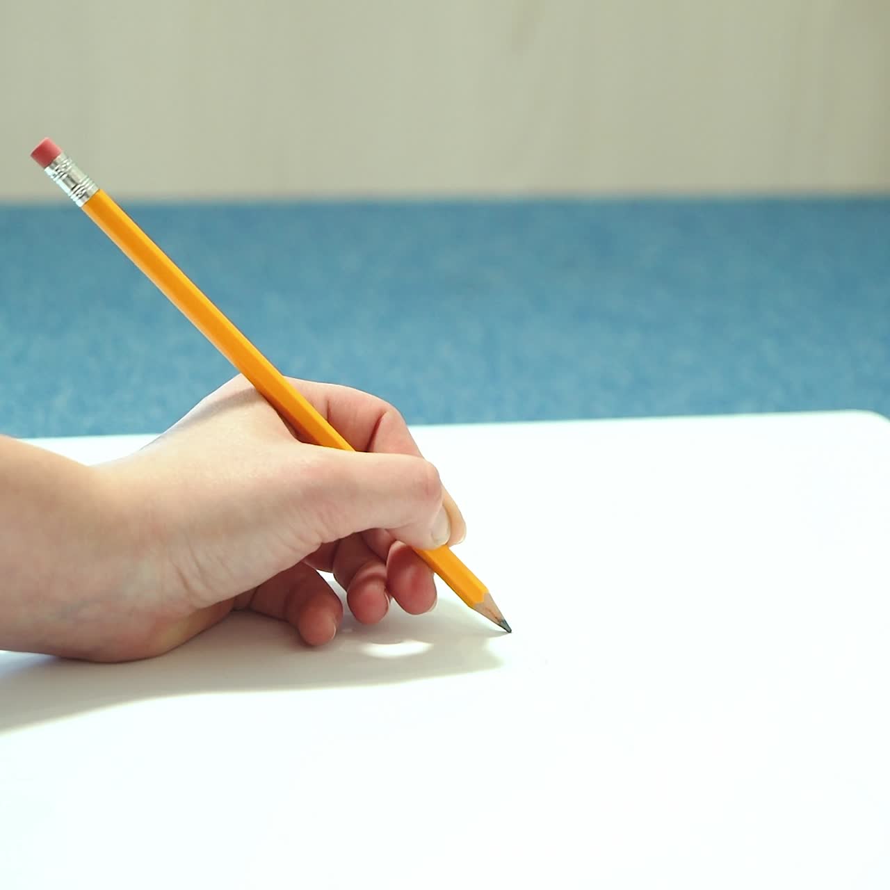 Female hand draws with a pencil. Young woman learns to draw.