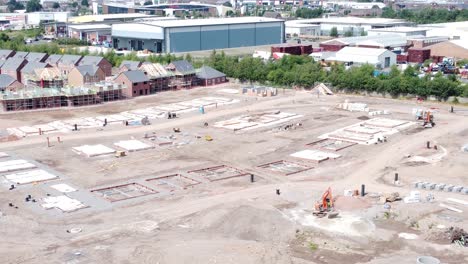 british town housing development building contractor working foundation construction site aerial view