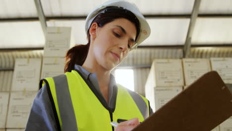 female technician writing in clipboard 4k