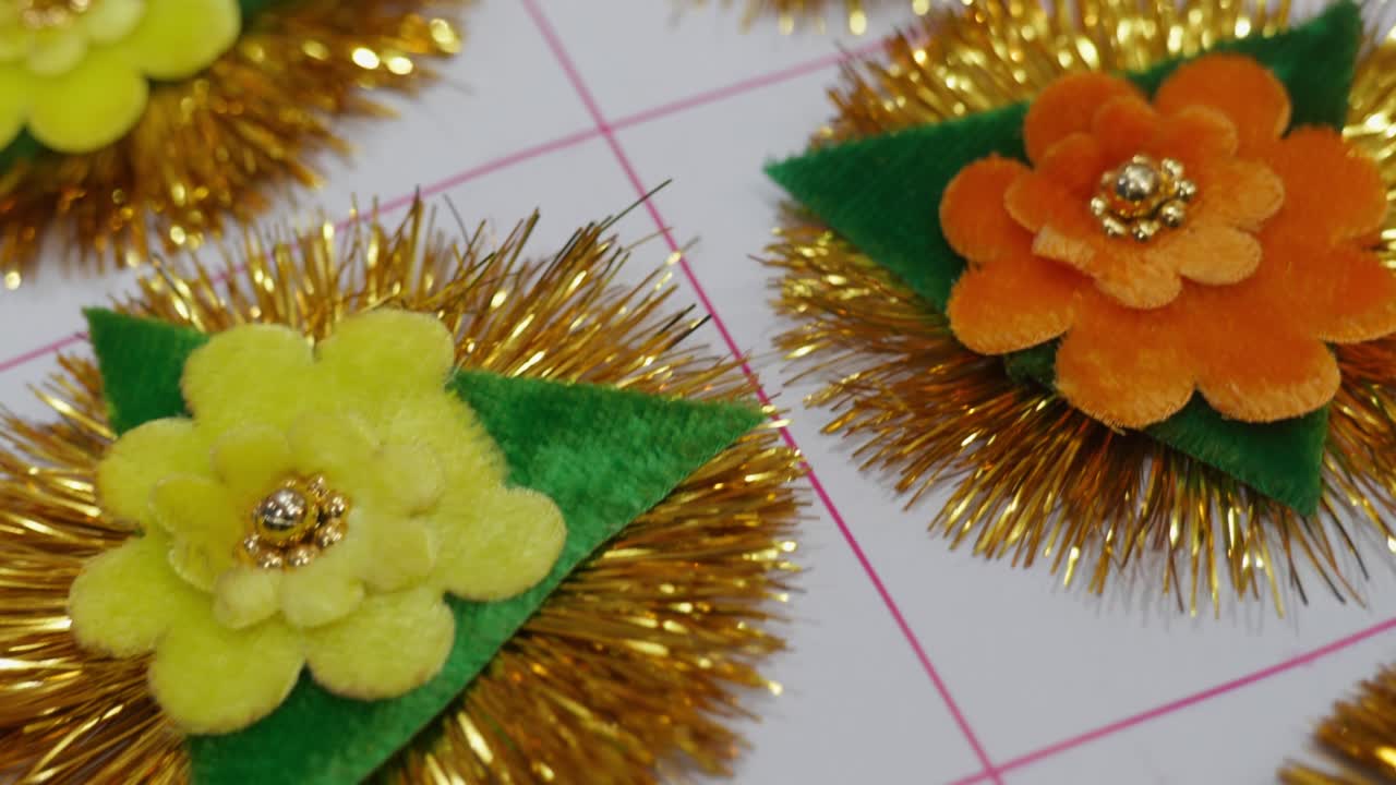 Handmade multiple colours of Rakhi with Floral Design and Golden Tinsel Decoration. interior shot, push in, 4k