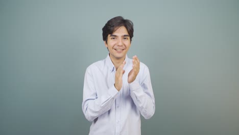 Man-clapping-excitedly-to-camera.