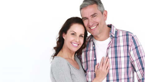 Smiling-couple-embracing-on-white-background