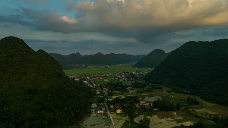 aerial view of a picturesque village nestled in a valley between lush green mountains in vietnam