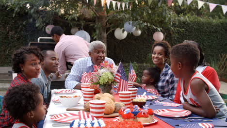 multi generation black family talking at 4th july barbecue