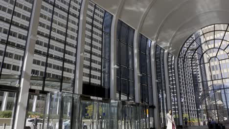 sunlit lobby of a modern office building in downtown chicago with people walking by
