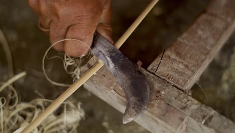 stripe of bamboo carved from a wooden stick with a sharp knife