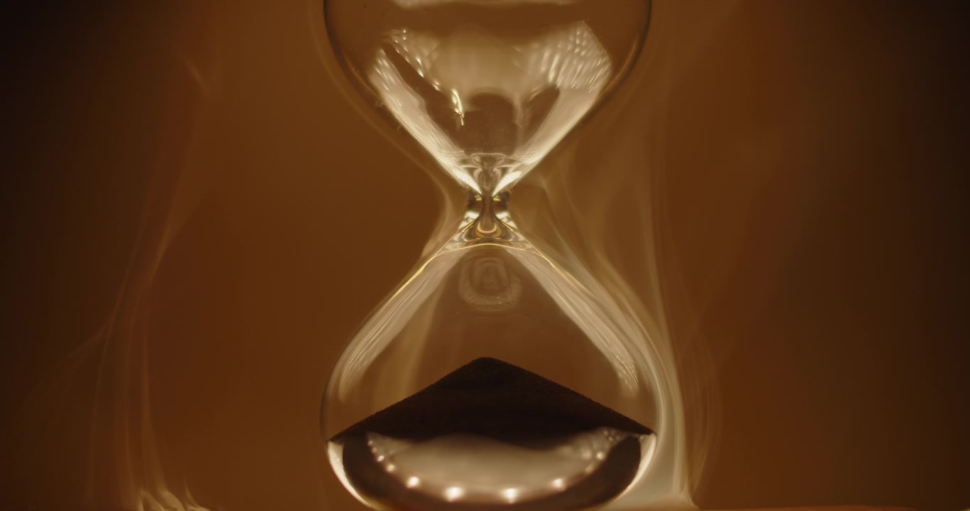 Hourglass on caramel colored background