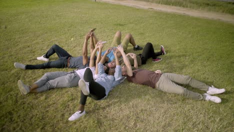 smiling young people using smartphones.