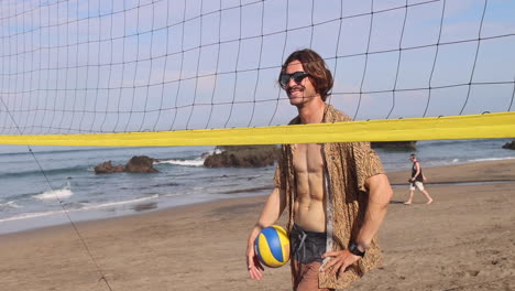 Happy-beach-volleyball-player-standing-near-the-net.