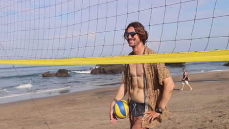 happy beach volleyball player standing near the net.