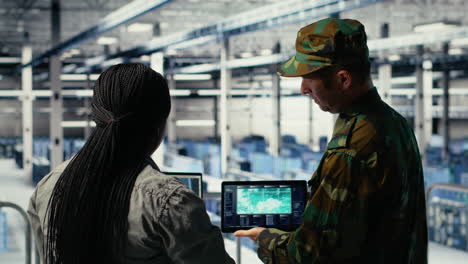 military commander and female programmer in data center tracking coordinates