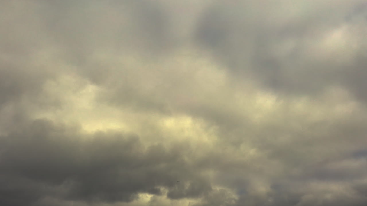Movement of clouds across the evening sky, creating a picturesque scene