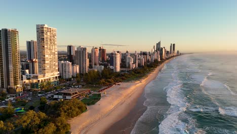 aerial view of gold coast's skyline and beach at sunrise, showcasing vibrant colors and serene ocean waves