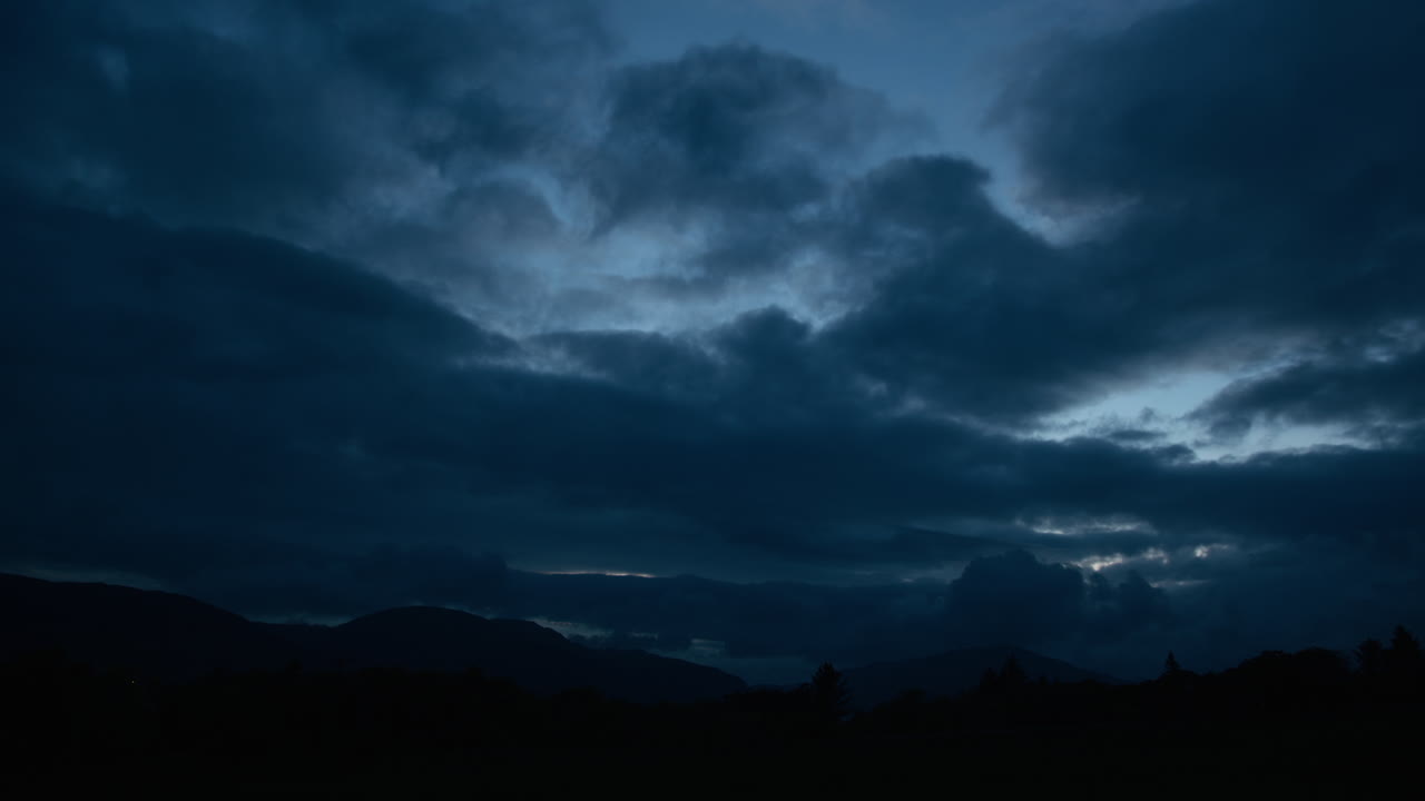 Dark and Dramatic Night Sky over Mountains