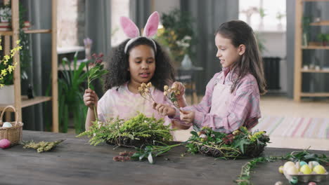 Cute Girls Making Flower Arrangement for Easter