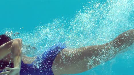 brunette woman swimming underwater