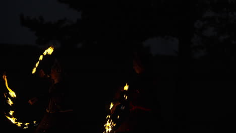 fire dancers at night