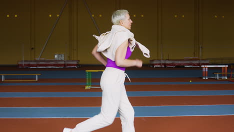 senior woman running indoors