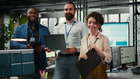 vertical video portrait of multiethnic employees work with performance metrics and high tech