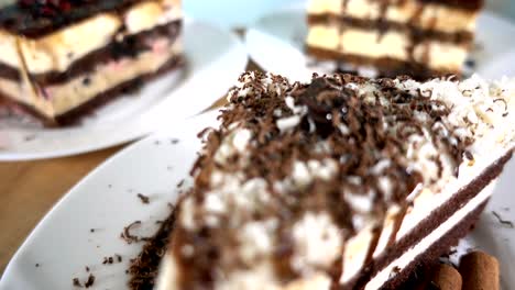 various slices of cakes on white plates rotating, 4k