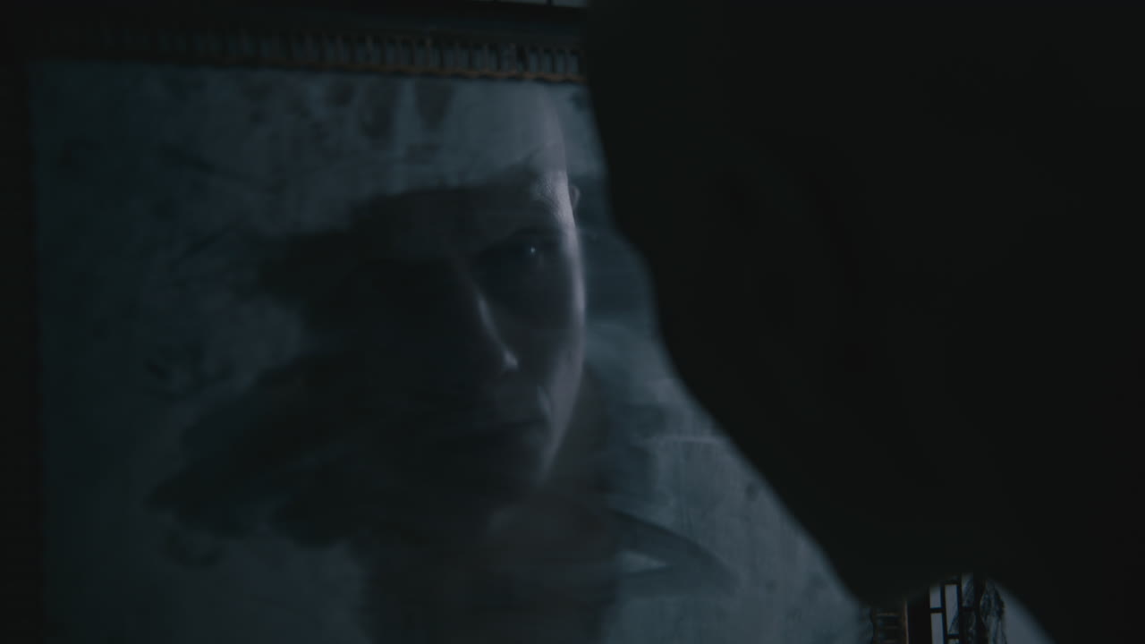 Pale bald skinny man looks into the mirror in the creepy old bathroom at night