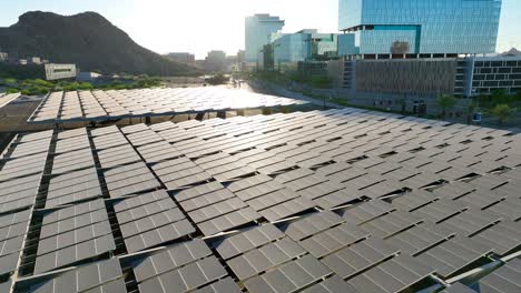 Solar-panels-above-parking-on-college-campus-near-upscale-corporate-skyscrapers