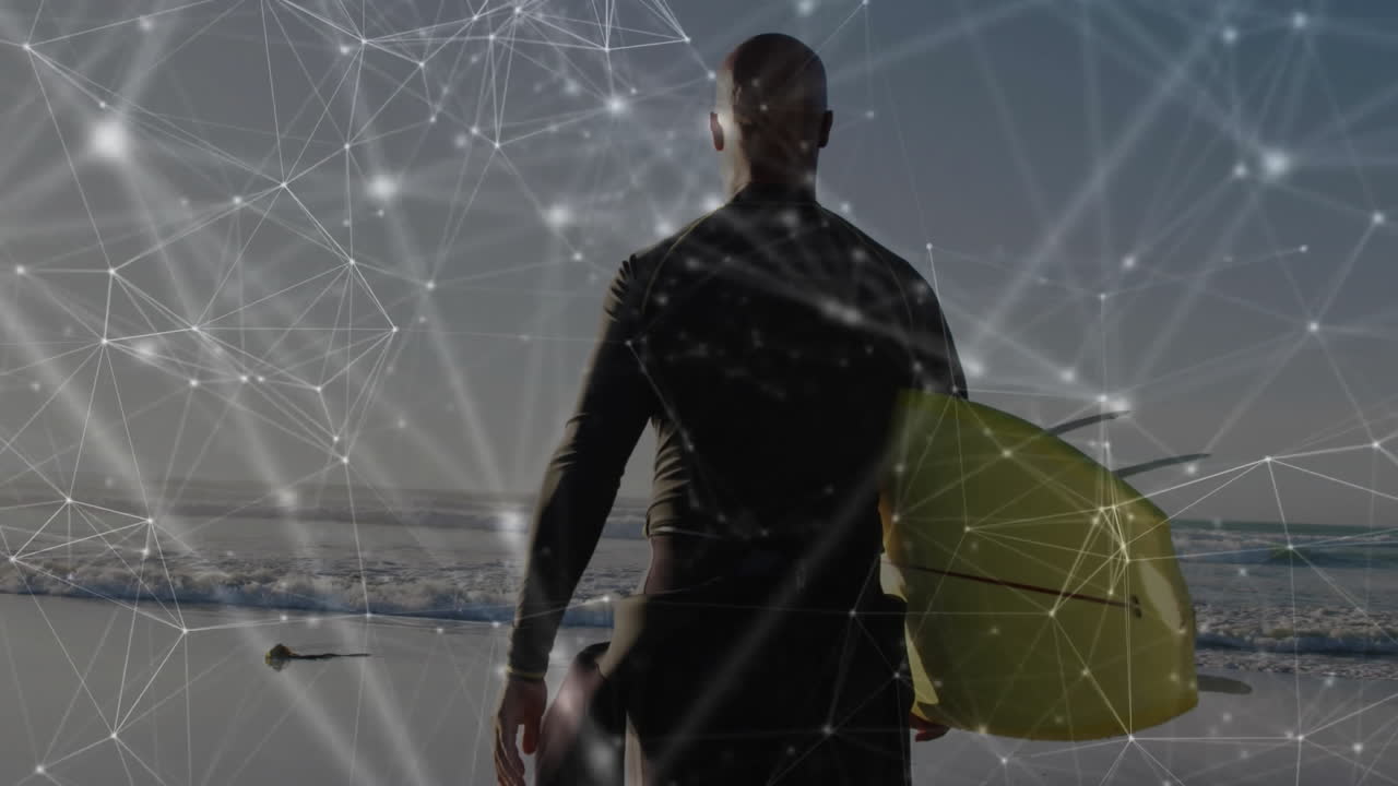 man wearing wetsuit holding surfboard on ocean beach, showcasing technology network overlay