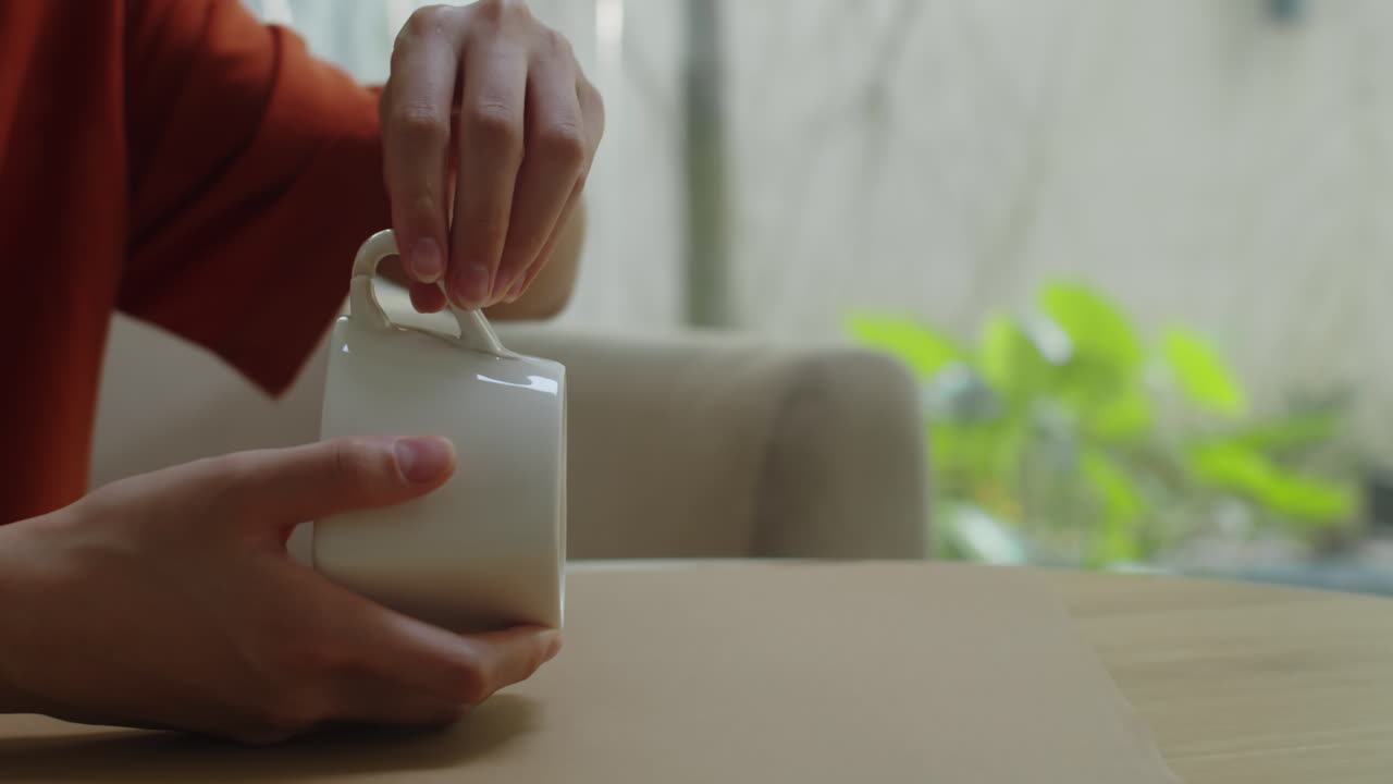 Person Adding Glue when Repairing Broken Mug