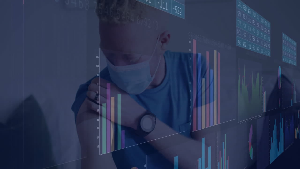 adult male wearing face mask inspecting upper arm on couch, with animated health charts floating