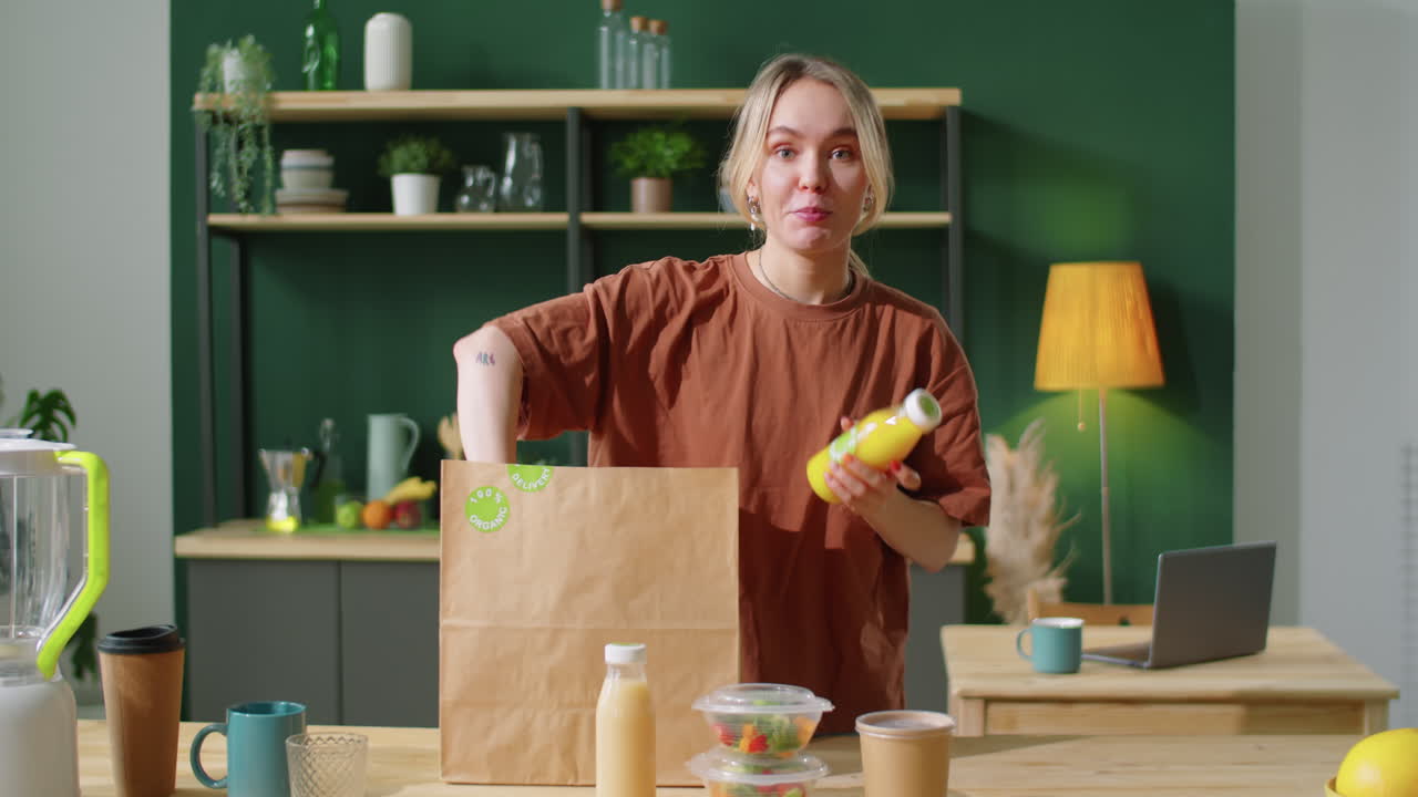 Female Blogger Unpacking Eco Food and Drinks and Talking at Camera